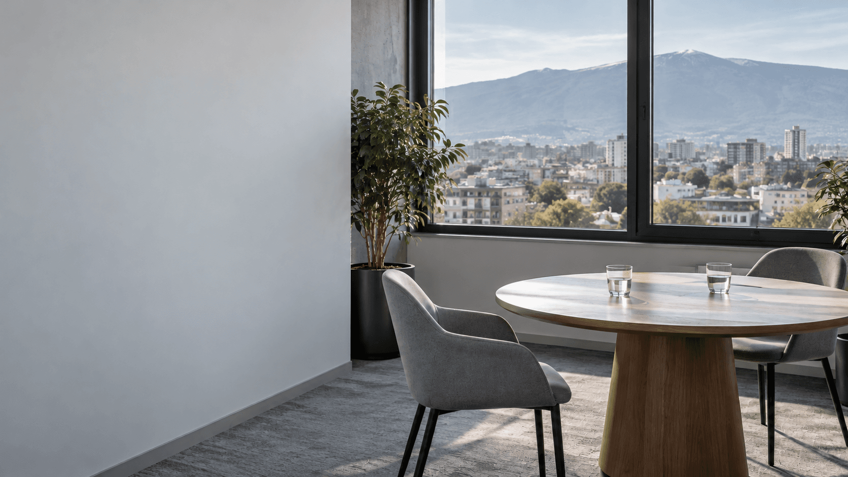An empty meeting room with a chair pulled out at a round table